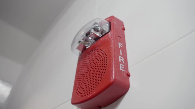 Close-up of a fire alarm on a white wall. Perfect for safety, emergency, alert, and fire protection system themes.