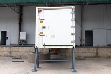 refrigerated shipping containers, cold stores in front of a warehouse,