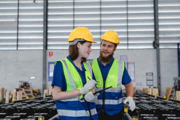 Workers at automotive parts warehouse inspect components and manage logistics operations under safe, organized, and well-lit storage conditions.
