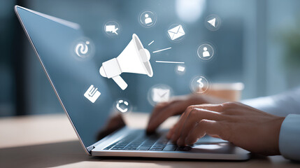 Digital marketing strategy. Announce promotions and campaigns via email and social media. Marketer using laptop computer to manage targeted advertising.