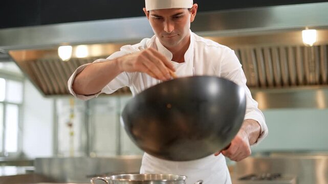Chef skillfully prepares a fresh dish over a sizzling pan, focused intently on every detail. With utmost care, he selects only the finest ingredients, respecting the freshness and flavor of each compo