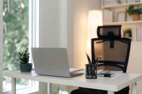 Modern home office setup featuring laptop and desk organizer