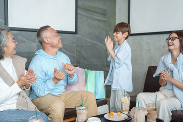 Fototapeta premium group of the generations family take a break coffee together at coffee shop,resting during travel,bonding grandson enjoy playing with grandfather