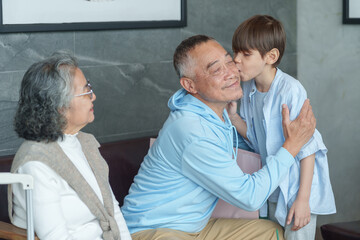 Fototapeta premium group of the generations family take a break coffee together at coffee shop,resting during travel,bonding grandson kiss on cheek grandfather