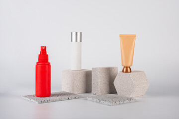 Plastic white tube for cream or lotion. Skin care or sunscreen cosmetic, Cosmetic red bottle....