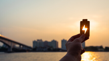 People in a common household holding a symbol of electricity to shine at the sun. The concept of...