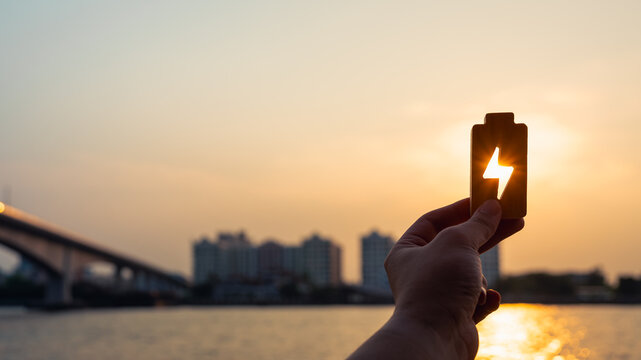 People in a common household holding a symbol of electricity to shine at the sun. The concept of household energy usage tends to increase along with the price and cost of electricity production.