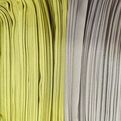 Rolled fabric in yellow and grey tones from top view