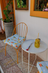 In the summer in Kas, Turkey, a spot in the shade of an open-air cafe has become available. A glass and a fan lie on the table.