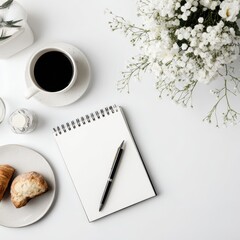White table, coffee, pastries, flowers, notepad
