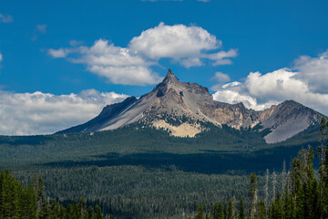Mount Thielsen, is an extinct shield volcano in the Oregon High Cascades.  Glaciers have heavily eroded the volcano's structure, creating precipitous slopes and a horn-like peak.