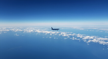High-altitude view of a jet plane over a vast expanse of clouds and ocean