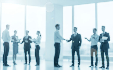 Obraz premium Business people in suits shaking hands in a bright office space.