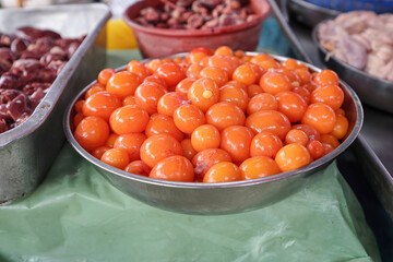 Eyerlekh raw unlaid chicken eggs yellow orange Asian delicacy sold at wet market stall