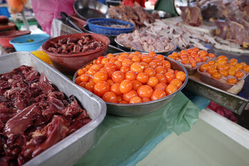 Eyerlekh raw unlaid chicken eggs yellow orange Asian delicacy sold at wet market stall