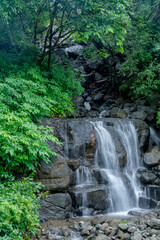 A waterfall during the monsoons near Pune India. Monsoon is the annual rainy season in India from...