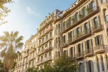 Elegant Facade Of Modernist Barcelona Apartments With Balconies And Palm Tree