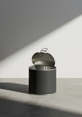 Open tin can on a concrete floor, studio shot