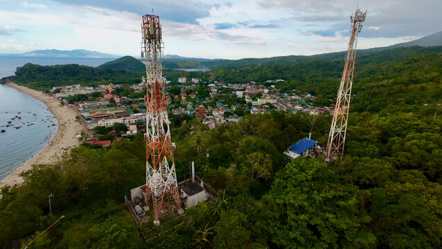 Aerial view of cell phone towers. Aerial view of telecommunications towers on top of a hill with a town in the background.