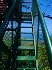 Metal staircase leading up. View of the iron staircase with steps and railings leading to the top of the tower.