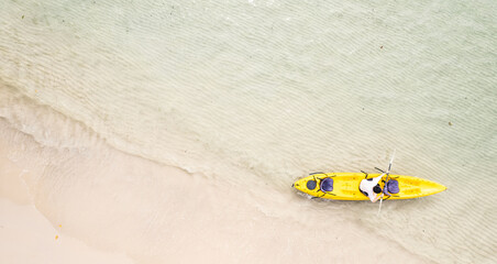 Aerial view of a kayak in the blue sea .man kayaking he does water sports activities.	