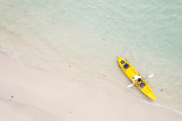Aerial view of a kayak in the blue sea .man kayaking he does water sports activities.	