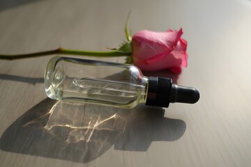 bottle of perfume with rose