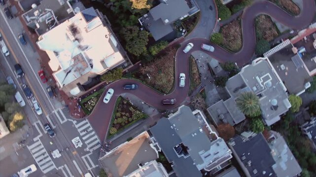 Timelapse of Lombard Street, known for its steep, one-block section with eight hairpin turns, in San Francisco, California, USA. Cars navigate the winding road.
