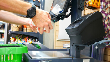 A man makes a purchase at a self-service checkout