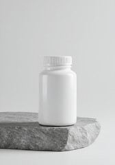White pill bottle on gray stone