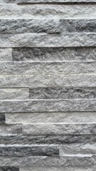 Gray stone wall texture provides a rustic and modern natural pattern for backdrops