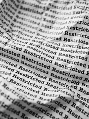 Words Restricted Seamless print on crumpled paper for business background.