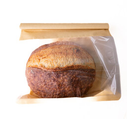 Sourdough Bread Loaf in Transparent Plastic Bag on White Background – Ready for Sale or Delivery