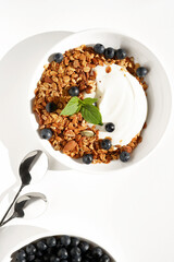 Healthy Nutrition, Breakfast. Fresh Greek Yogurt with Homemade Granola with Almonds, Seeds, Walnuts, and Blueberries.                          