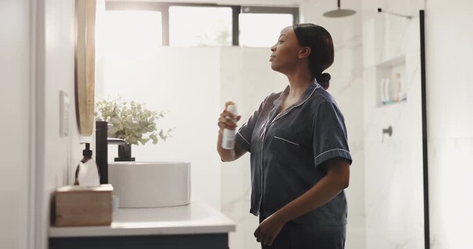 Home, deodorant and black woman in bathroom with spray for scent, fragrance and grooming. Morning routine, health and person with cosmetic products, perfume and fresh for hygiene, wellness and smell