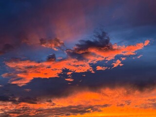 Fiery sunset sky clouds glowing sundown.