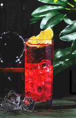 red el diablo cocktail garnished with lime slices, showcasing refreshing flavors in an inviting lounge setting