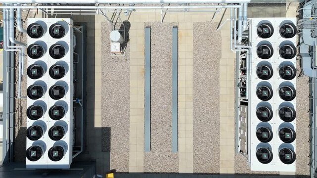 Cinematic aerial footage of rotating turbine fans atop a quantum tech server farm in England