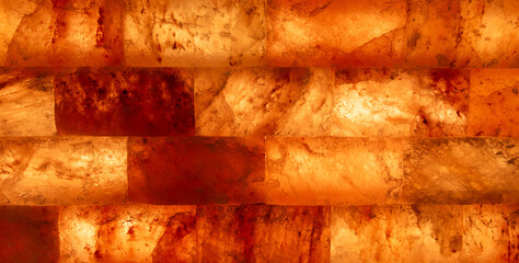 Wall of mineral rock salt forming a brick shape, as background, perfect for healthy cooking and wellness