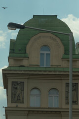 A beautiful and sustainable building featuring an environmentally friendly green roof along with a classic street light nearby