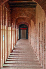 Historic Brick Arched Cellular Jail  Andaman Hallway with Sunlight and Shadows Extending Into the...
