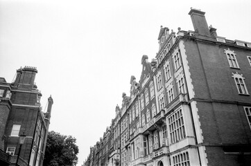 Vintage grainy analog photo of elegant brick buildings in london