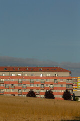 In the center of a vast field, there stands a large and impressive building topped with a striking...