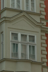 A large and impressive building that features numerous windows adorning its facade, enhancing its...