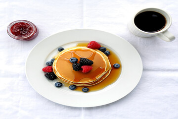 Golden pancakes with berries and coffee blueberries