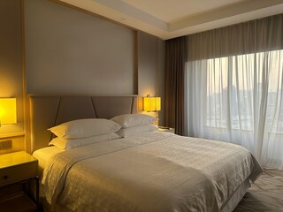 Bed with pillows, headboard in bedroom
