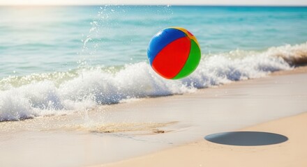Obraz premium Colorful Beach Ball Floating in Ocean Waves on Sandy Shore
