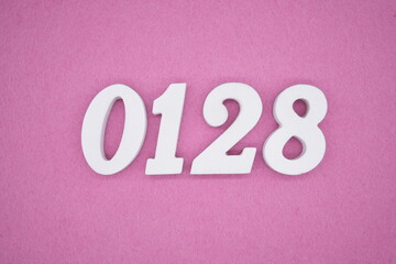 The numbers are made of white painted wood, placed on a pink paper background.