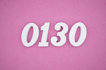 The numbers are made of white painted wood, placed on a pink paper background.
