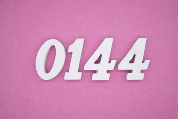The numbers are made of white painted wood, placed on a pink paper background.